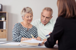 Older couple consulting with an attorney